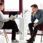 Psychologist discussing career counselling and life coaching options with a client